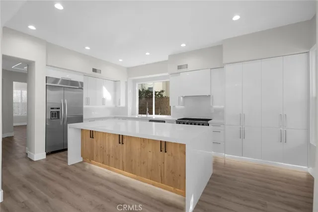 a kitchen with stainless steel appliances granite countertop a stove and a refrigerator