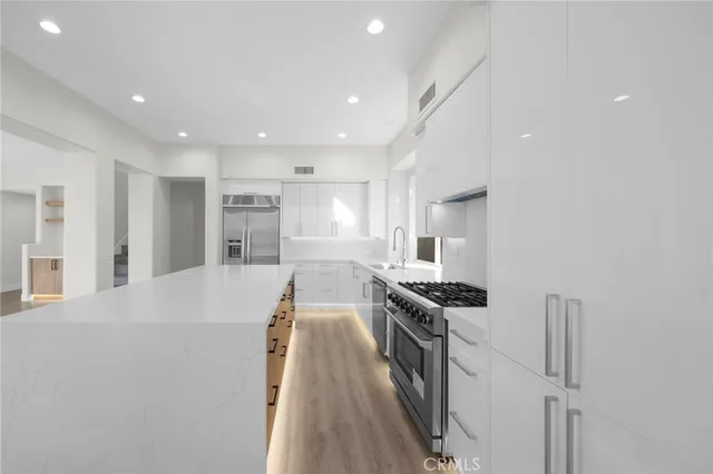 a kitchen with stainless steel appliances granite countertop a stove and a refrigerator