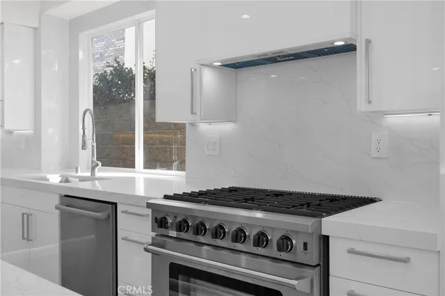 a kitchen with a stove and a white cabinet