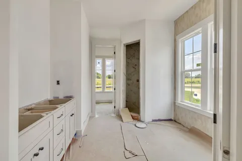 an empty room with windows and wooden floor