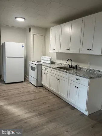 a kitchen with appliances cabinets and a sink