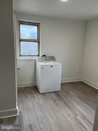 a view of a room with wooden floor and window