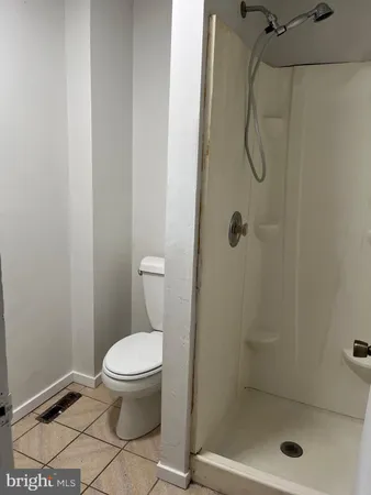 a bathroom with a toilet and a shower