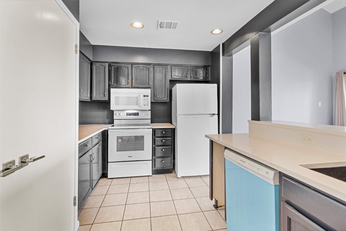 50 April Point Drive South Conroe, TX 77356 - Photo 11 of 30 a kitchen with a stove a refrigerator and a sink