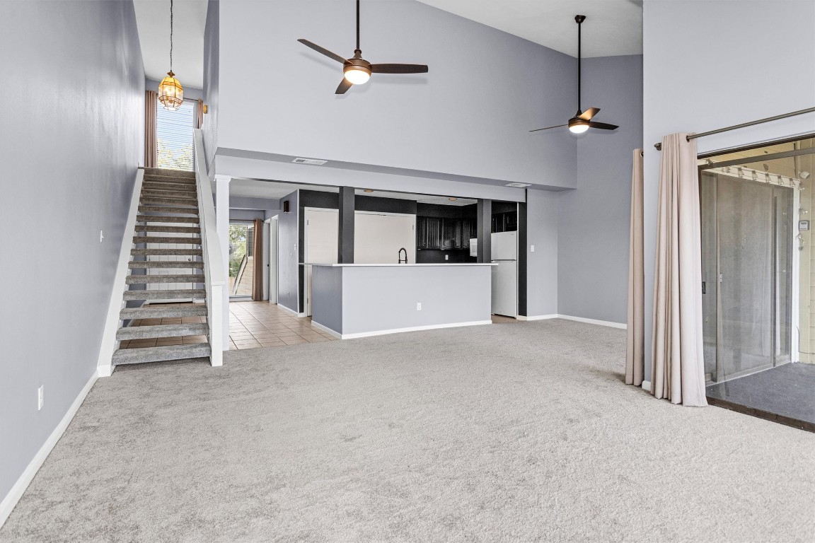 50 April Point Drive South Conroe, TX 77356 - Photo 20 of 30 wooden floor in an empty room with a fireplace and a chandelier