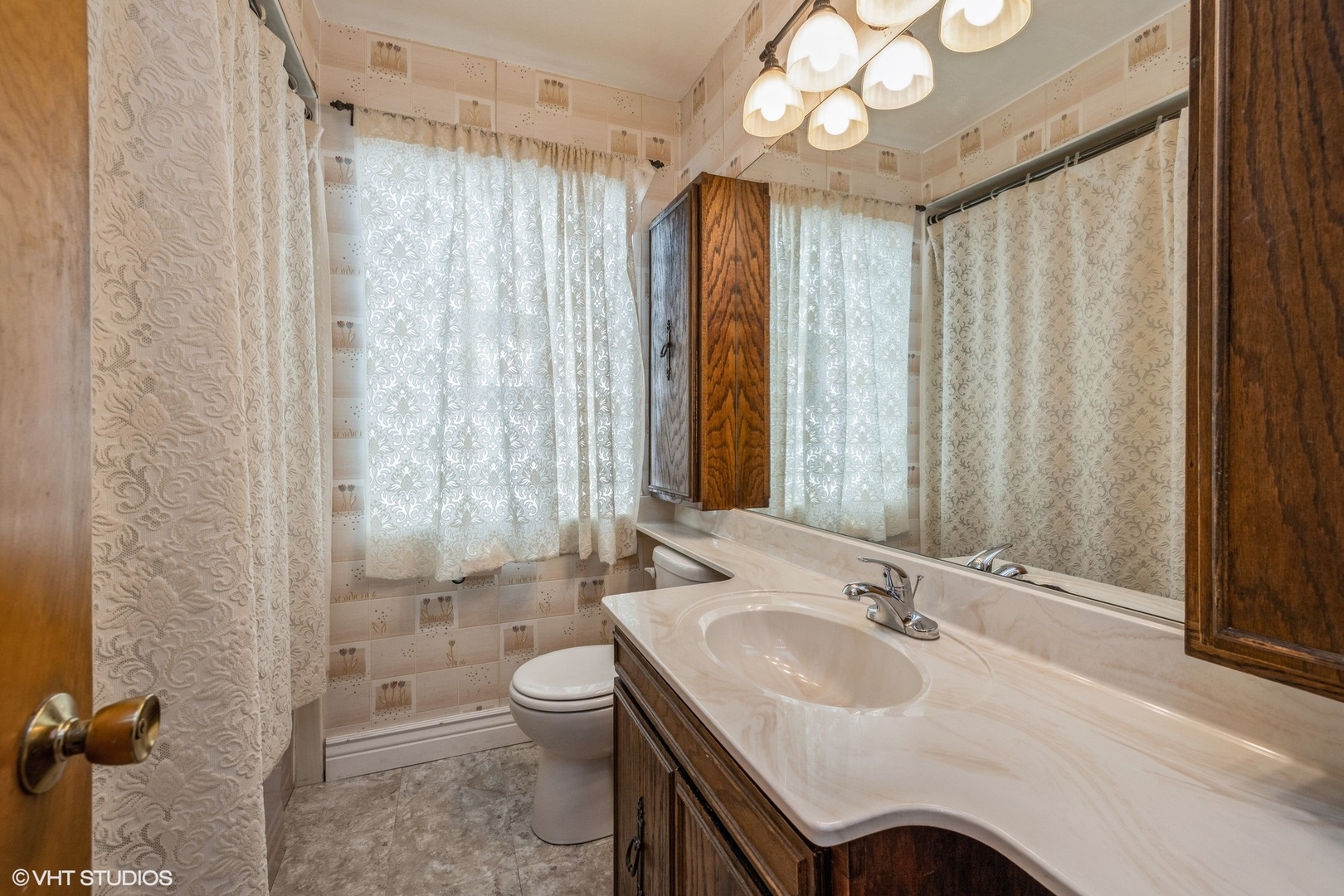 4123 Maple Avenue Brookfield, IL 60513 - Photo 11 of 18 a bathroom with a sink a toilet a mirror and a shower