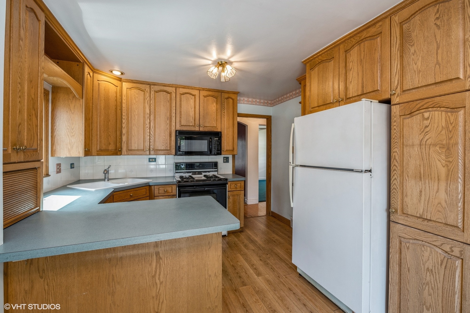 4123 Maple Avenue Brookfield, IL 60513 - Photo 6 of 18 a kitchen with a refrigerator a microwave a sink and a stove