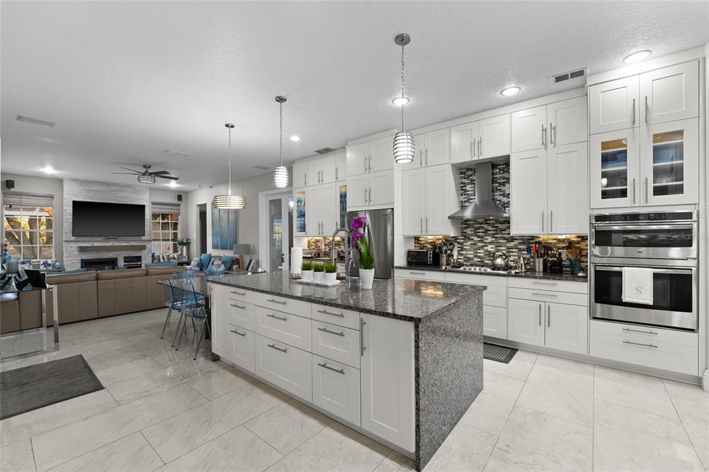 6001 Caymus Loop Windermere, FL 34786 - Photo 11 of 44 a kitchen with stainless steel appliances kitchen island granite top and stove