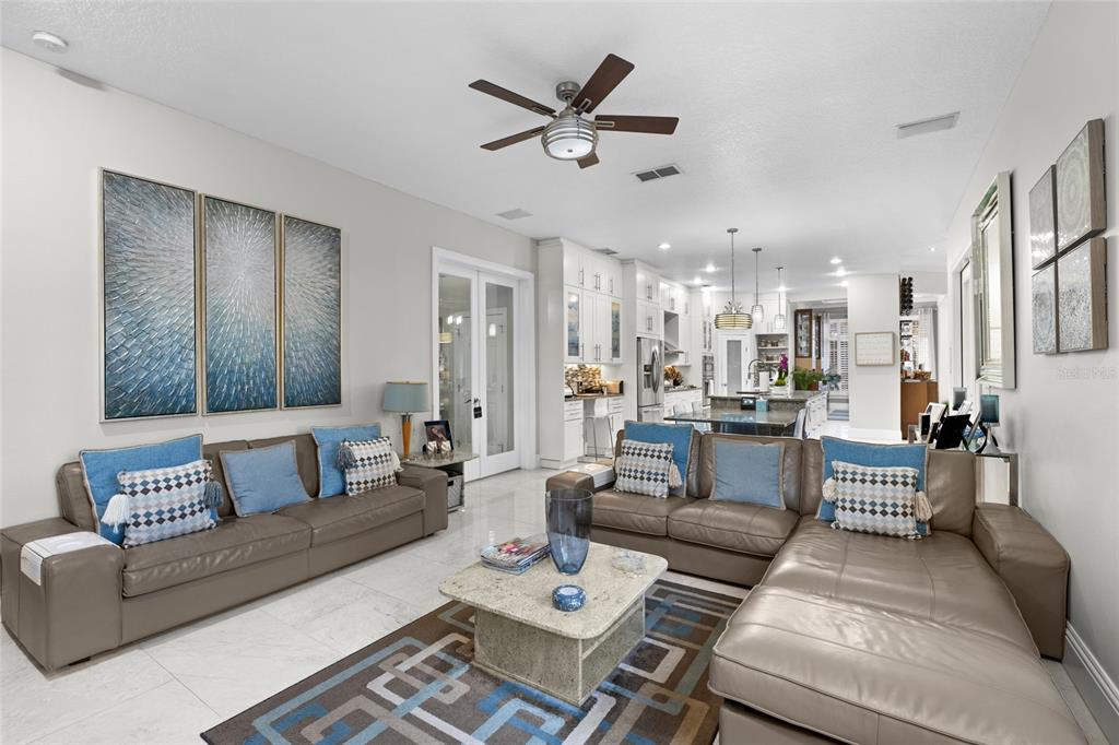 6001 Caymus Loop Windermere, FL 34786 - Photo 15 of 44 a living room with furniture kitchen view and a chandelier
