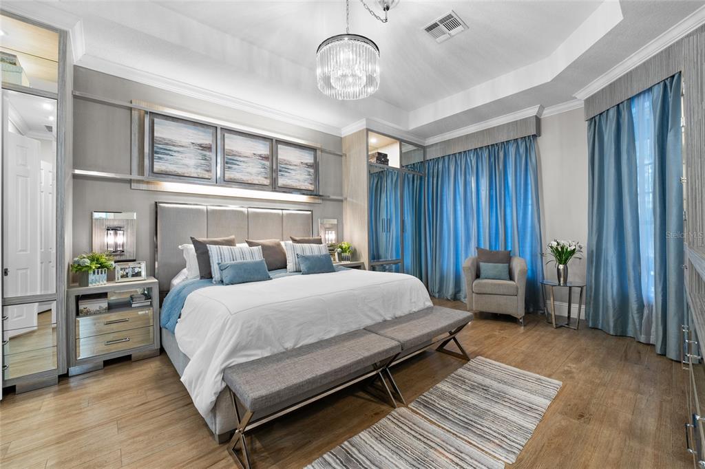 6001 Caymus Loop Windermere, FL 34786 - Photo 19 of 44 a bedroom with a bed a chandelier and a window