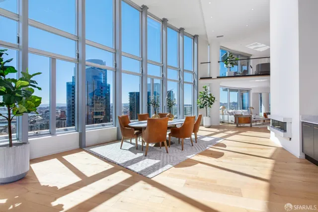 a view of a patio with couches table and chairs and potted plants