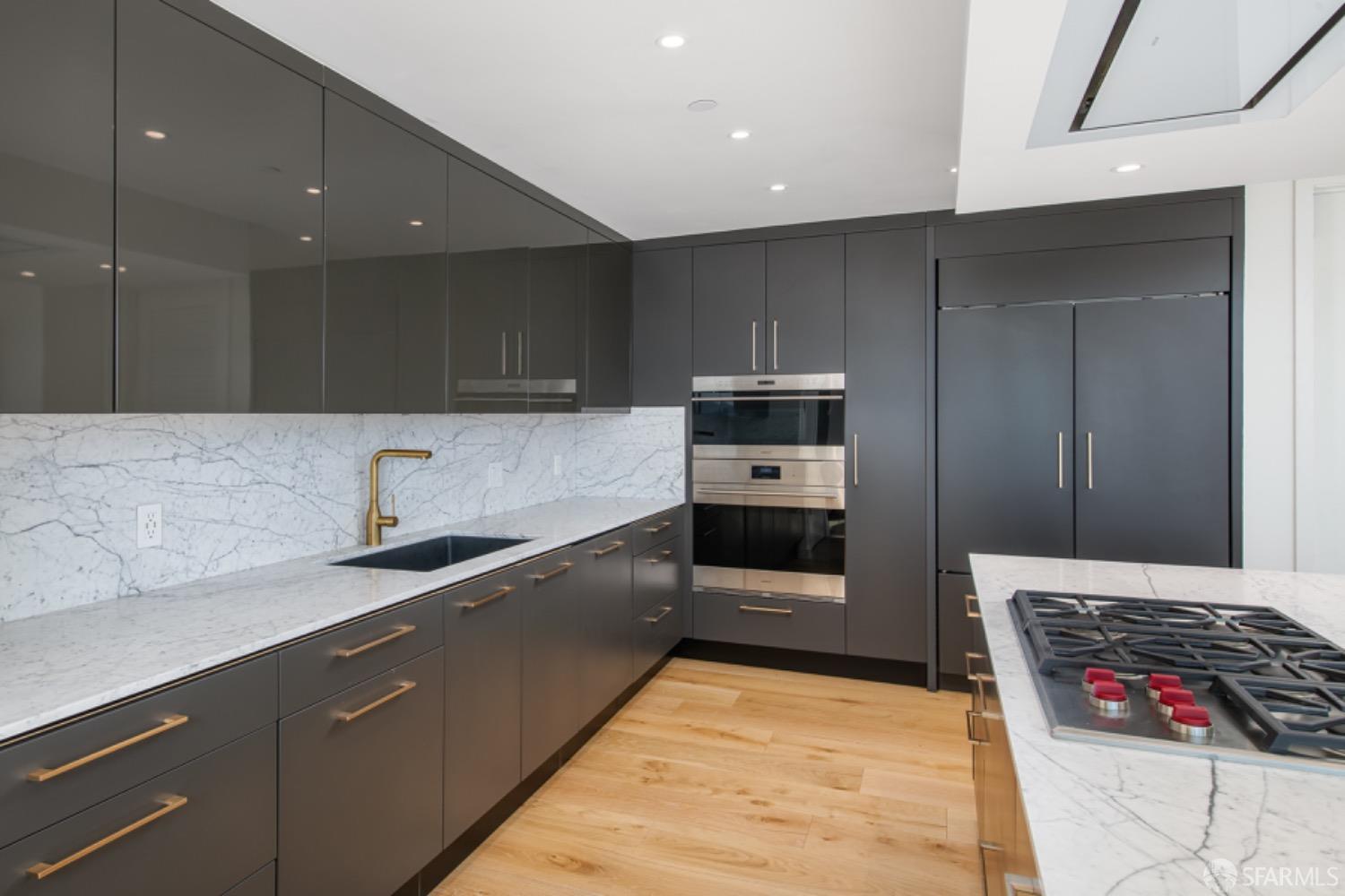 201 Folsom Street, Unit PH41C San Francisco, CA 94105 - Photo 15 of 72 a kitchen with stainless steel appliances granite countertop a stove a sink and a microwave
