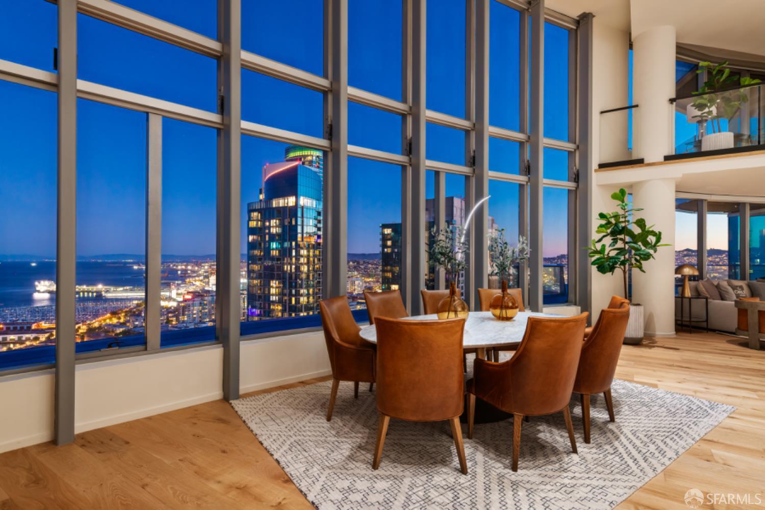 201 Folsom Street, Unit PH41C San Francisco, CA 94105 - Photo 2 of 72 a dining room with furniture and a potted plant