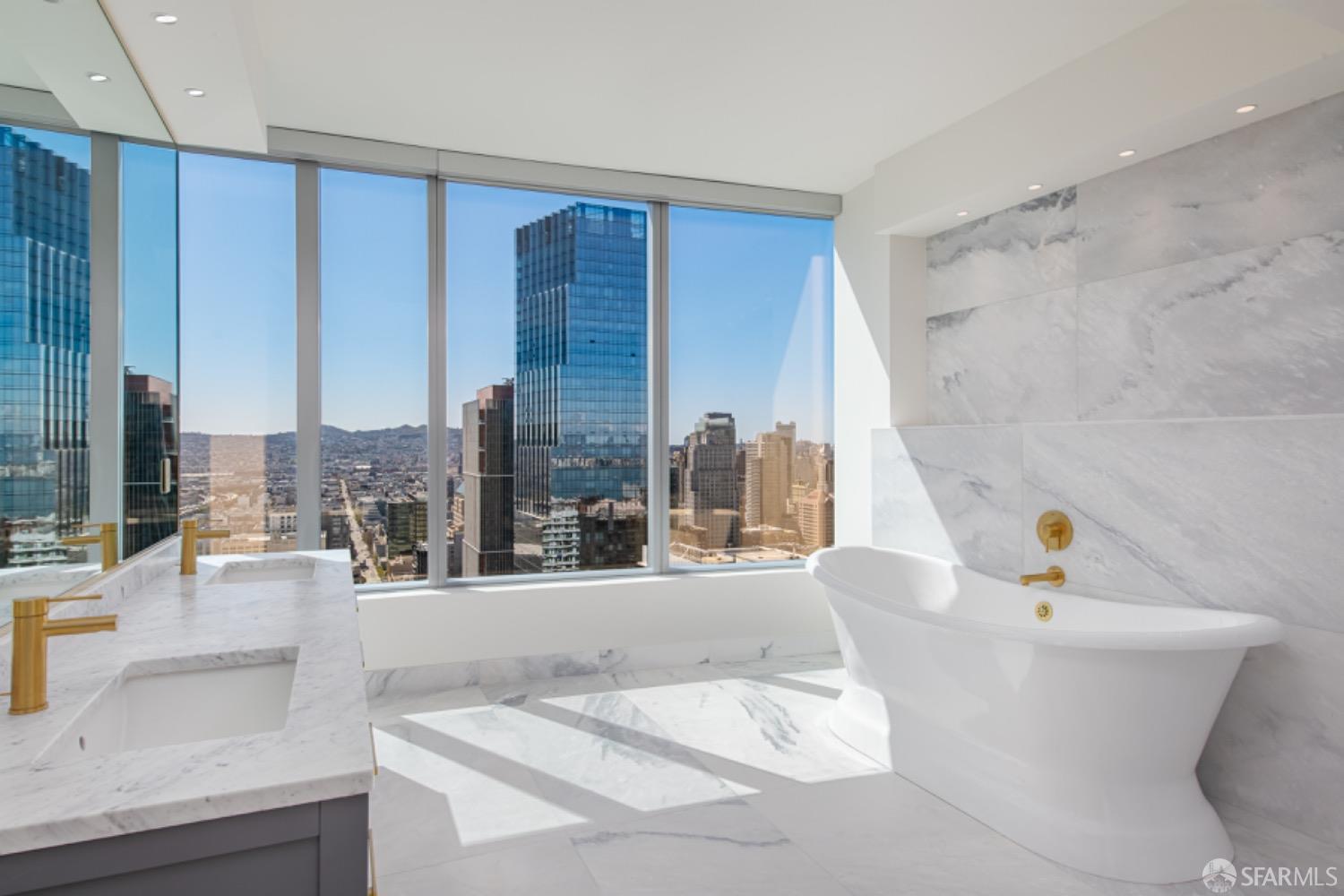 201 Folsom Street, Unit PH41C San Francisco, CA 94105 - Photo 25 of 72 a bathroom with a tub sink and mirror
