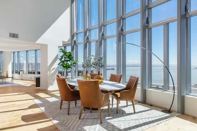 a dining room with furniture and wooden floor