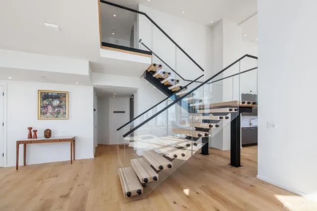 a living room with stainless steel appliances kitchen island granite countertop a couch and a view of living room