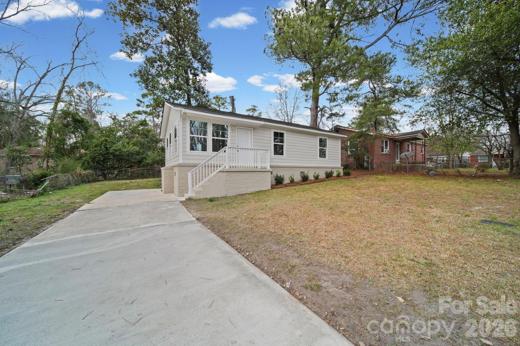 4913 Jones Street, Unit 12 Columbia, SC 29203 - Photo 2 of 17 a view of a house with a yard and large tree