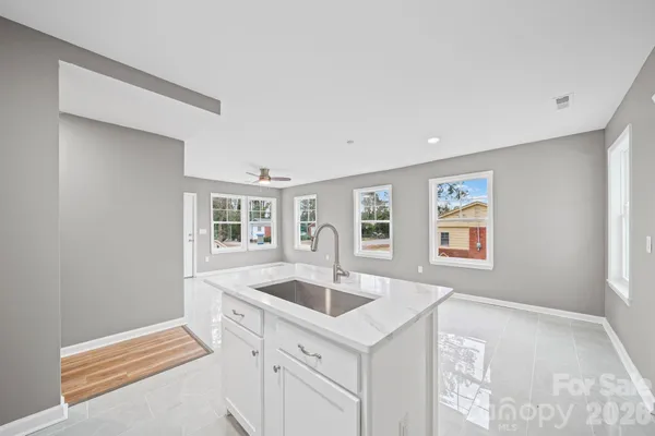 a kitchen with a sink cabinets and window