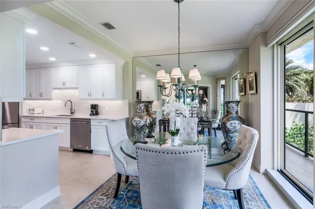 a view of a dining room with furniture a chandelier and wooden floor
