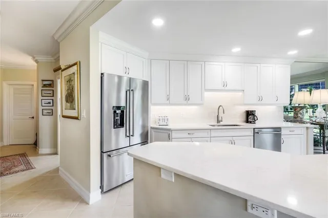 a kitchen with stainless steel appliances a refrigerator and a stove top oven