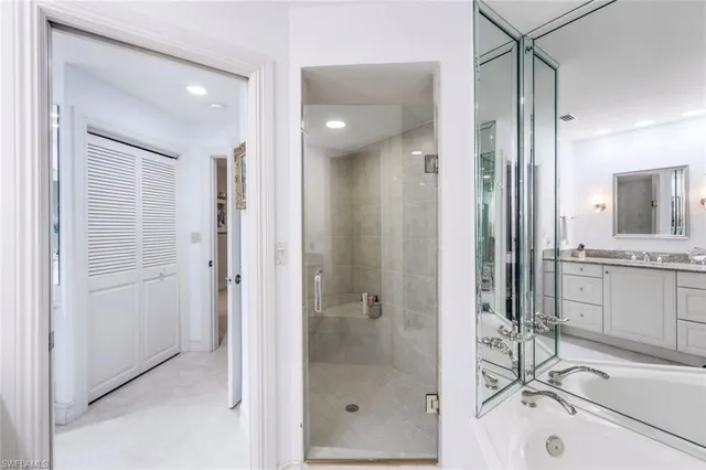 a bathroom with a shower sink vanity and mirror