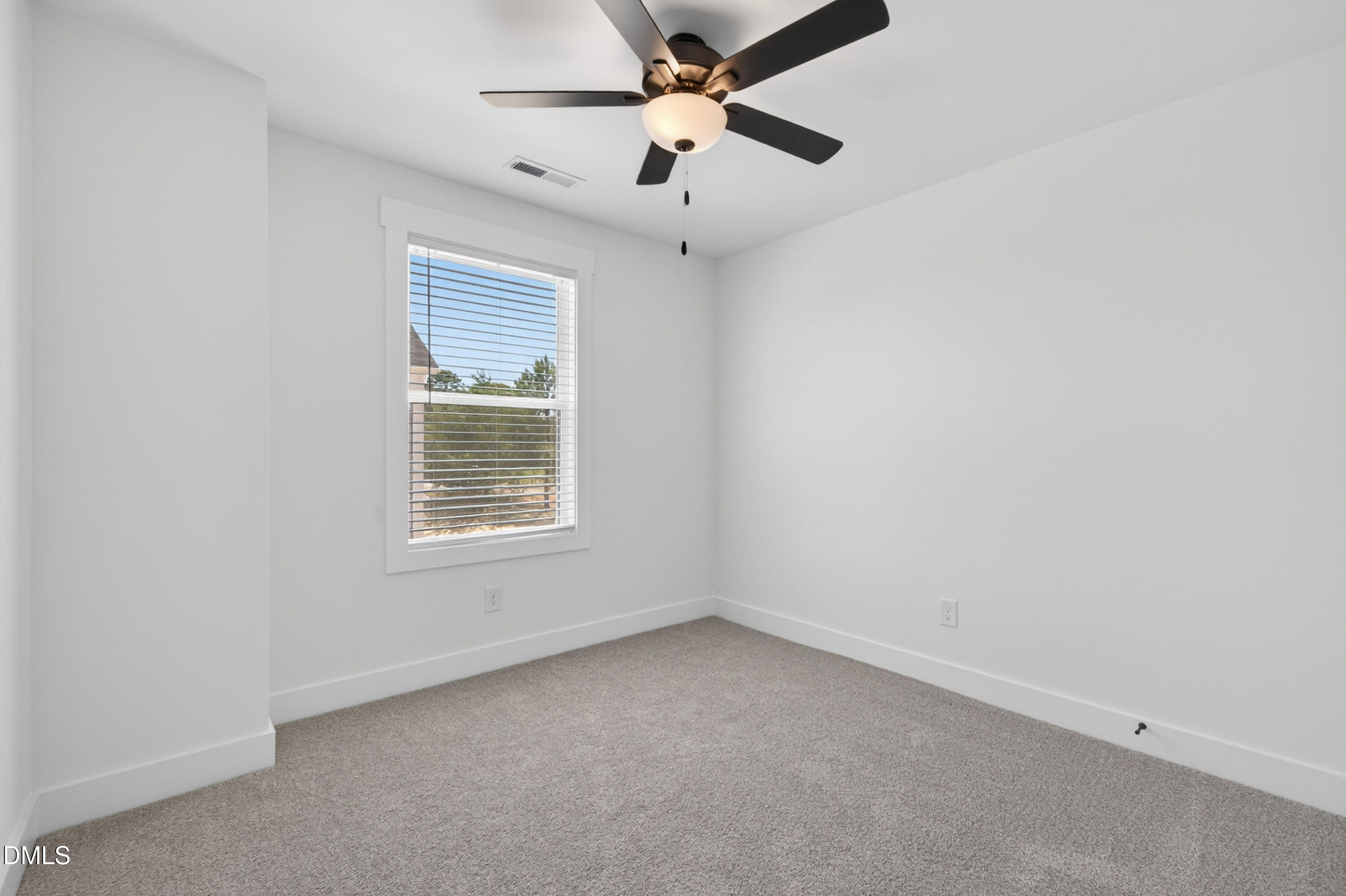 1182 Hurdle Mills Road Roxboro, NC 27573 - Photo 30 of 45 an empty room with a window and a fan