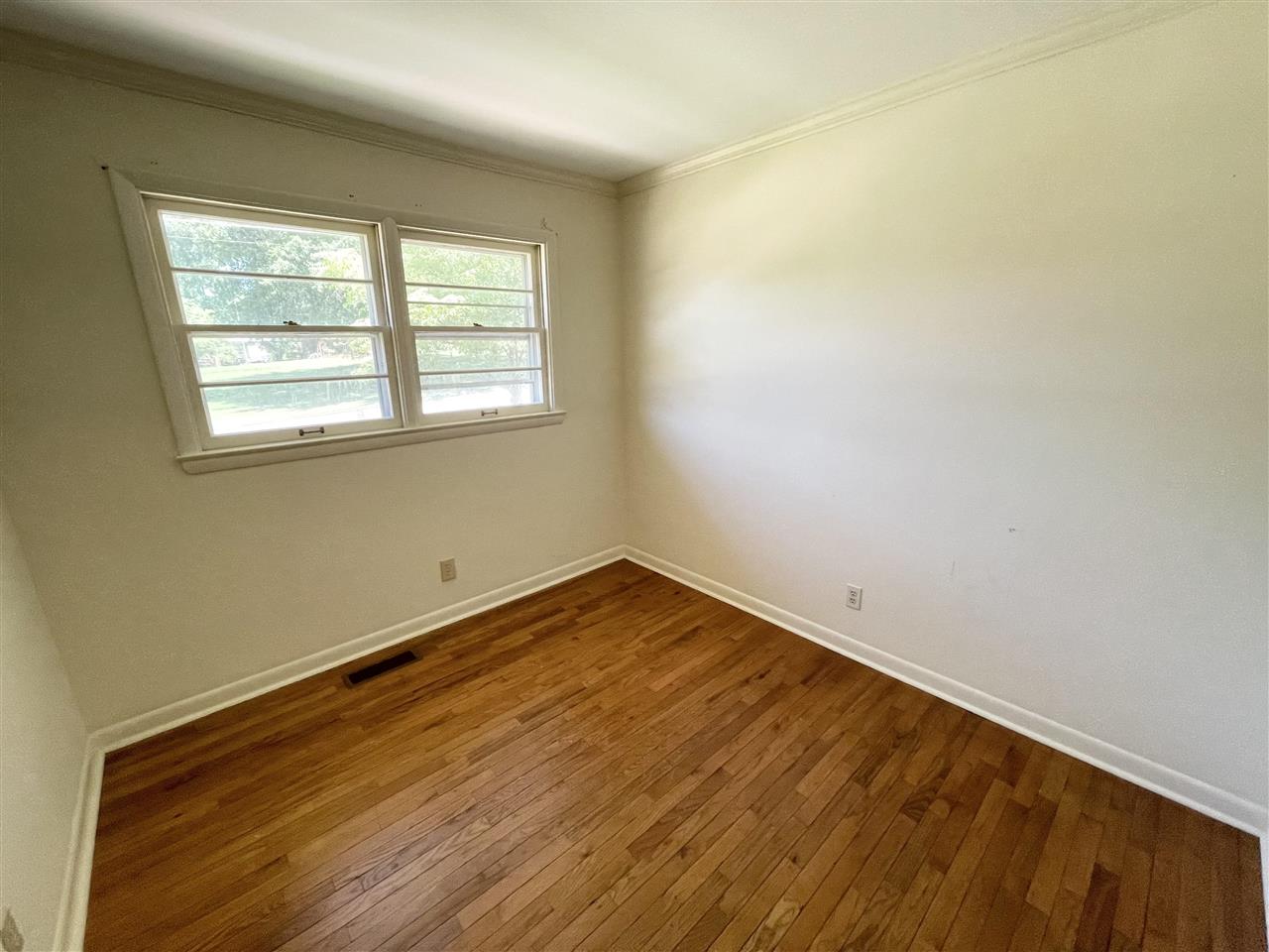 256 Thompson Drive Ripley, TN 38063 - Photo 11 of 17 an empty room with wooden floor and windows
