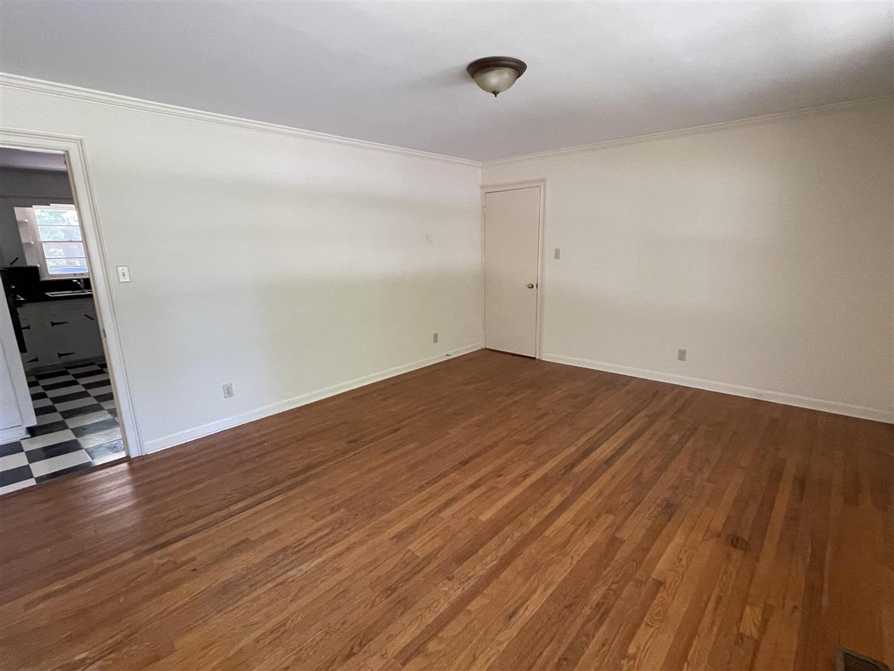 256 Thompson Drive Ripley, TN 38063 - Photo 15 of 17 an empty room with wooden floor and windows