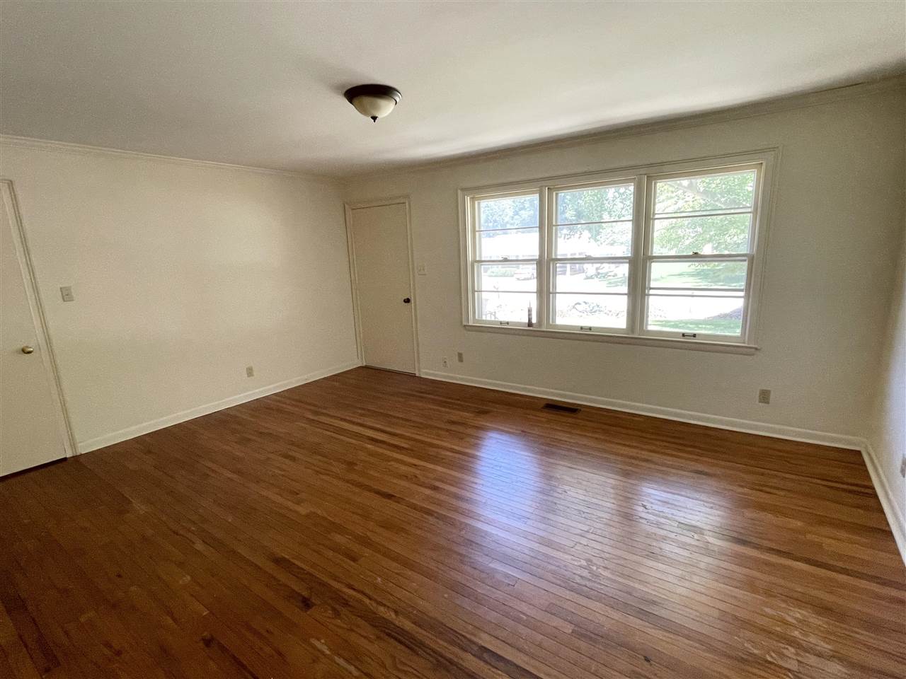 256 Thompson Drive Ripley, TN 38063 - Photo 16 of 17 an empty room with wooden floor and windows