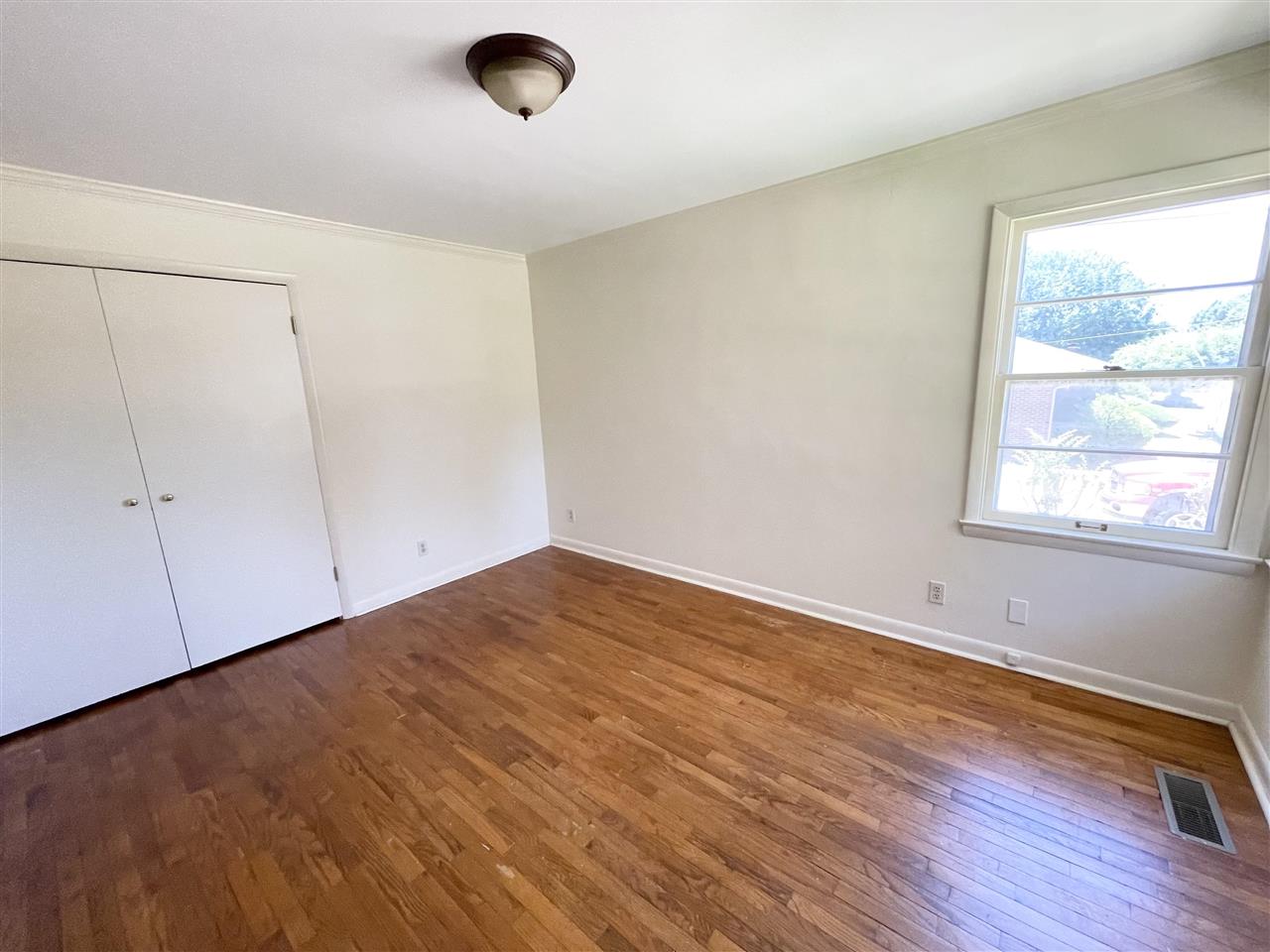 256 Thompson Drive Ripley, TN 38063 - Photo 9 of 17 an empty room with wooden floor and windows