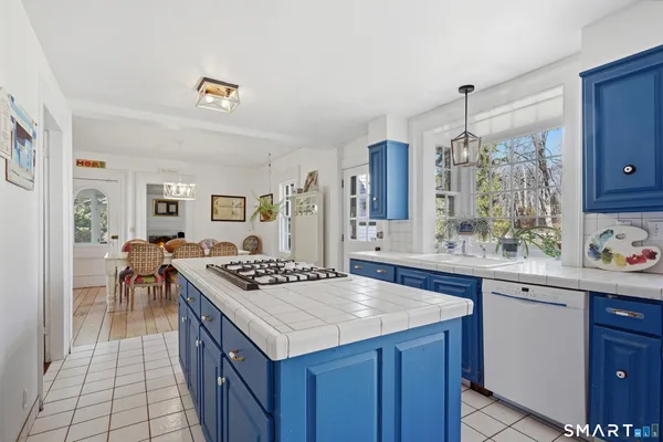 a kitchen with a stove a sink dishwasher and a refrigerator