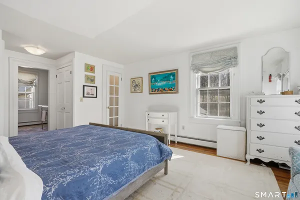 a spacious bedroom with a bed and cabinets