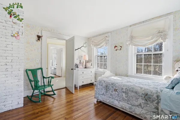 a bedroom with a bed and a chair