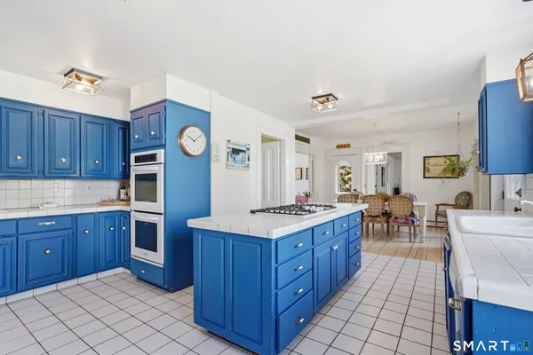 a kitchen with a stove a sink and a refrigerator