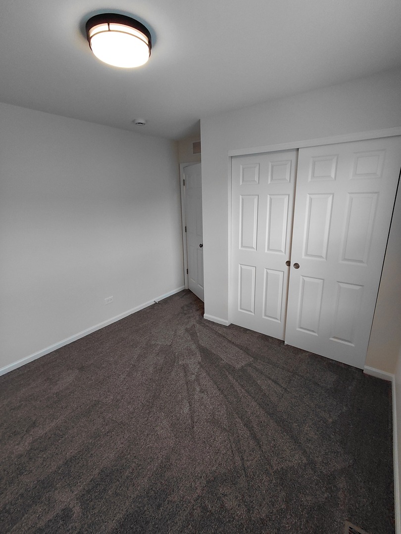 7214 Bradley Drive Plainfield, IL 60586 - Photo 19 of 21 an empty room with windows