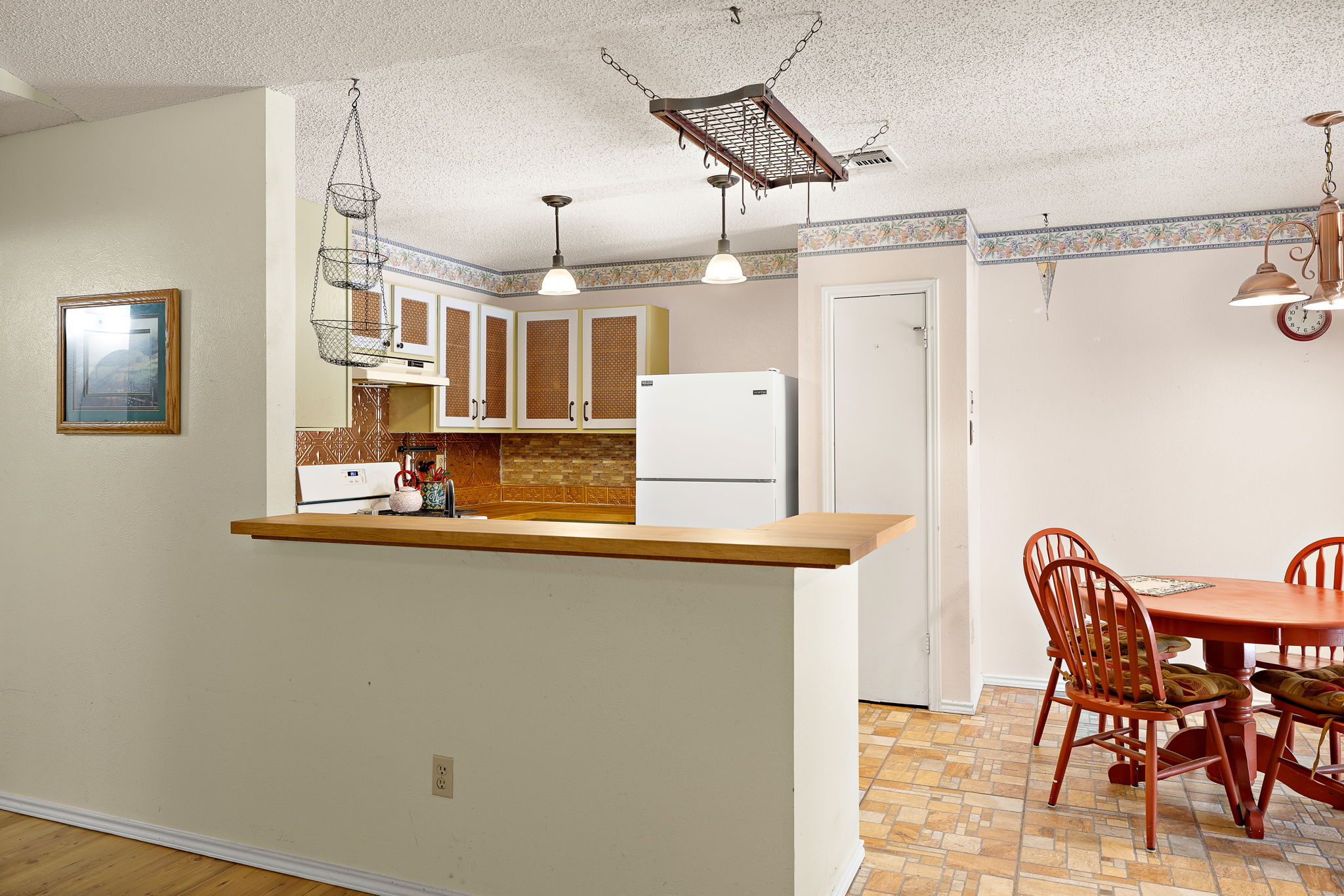 11709 Rotherham Drive Austin, TX 78753 - Photo 6 of 25 A functional kitchen with a practical breakfast bar opens to a cozy dining area.