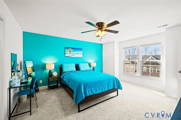 a bedroom with a bed and a view of living room