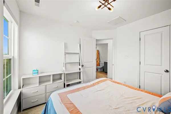 a bathroom with a sink vanity mirror and toilet
