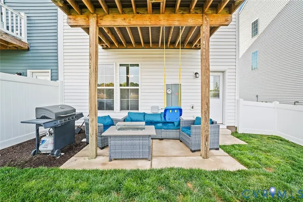 a patio with table and chairs and potted plants