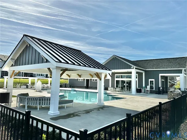 a view of a swimming pool and lounge chairs