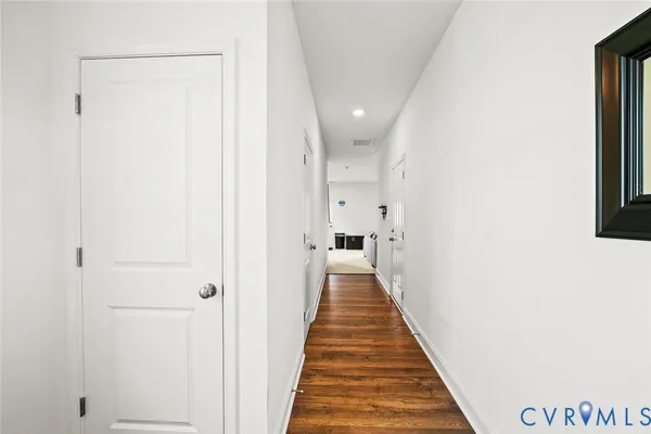 a view of a hallway with wooden floor