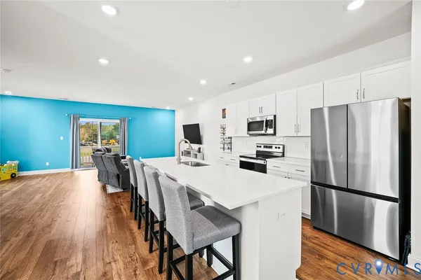a kitchen with stainless steel appliances a refrigerator and a stove top oven