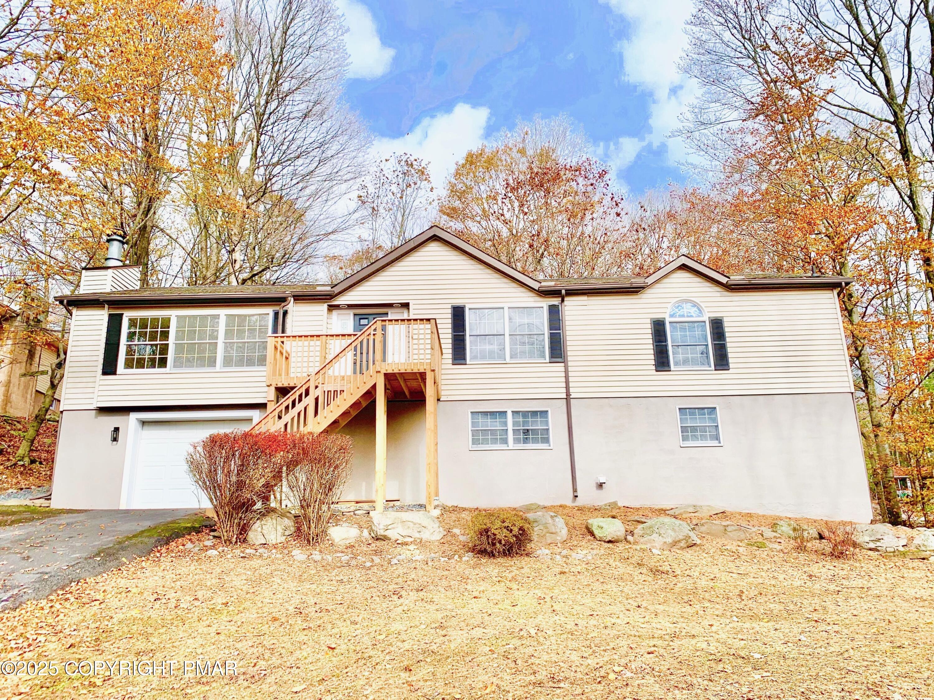 111 Lake In The Clouds Road Canadensis, PA 18325 - Photo 2 of 39 a front view of a house with a yard covered in snow