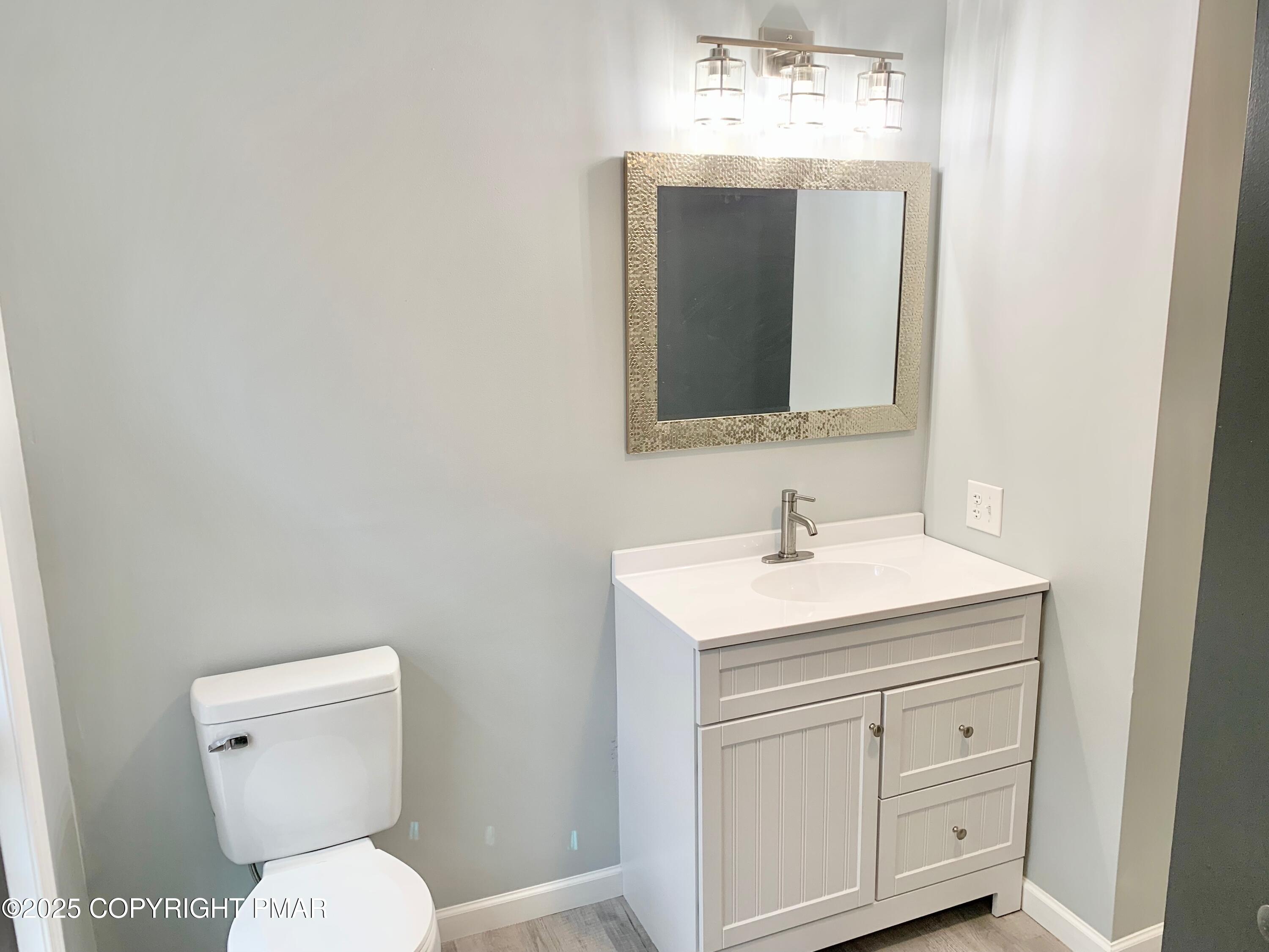 111 Lake In The Clouds Road Canadensis, PA 18325 - Photo 25 of 39 a bathroom with a toilet sink and mirror