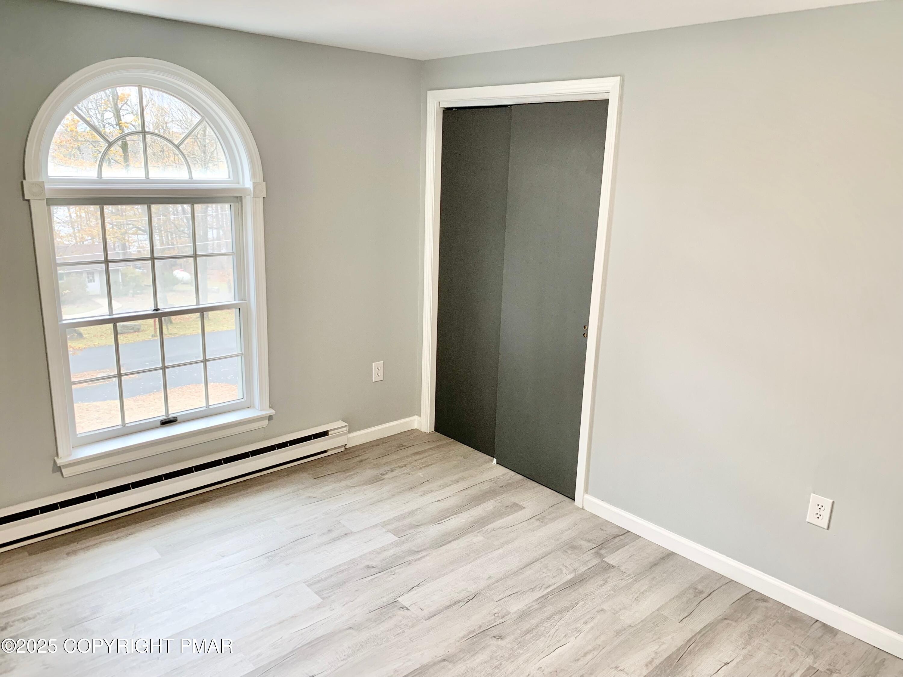 111 Lake In The Clouds Road Canadensis, PA 18325 - Photo 28 of 39 an empty room with wooden floor cabinet and windows
