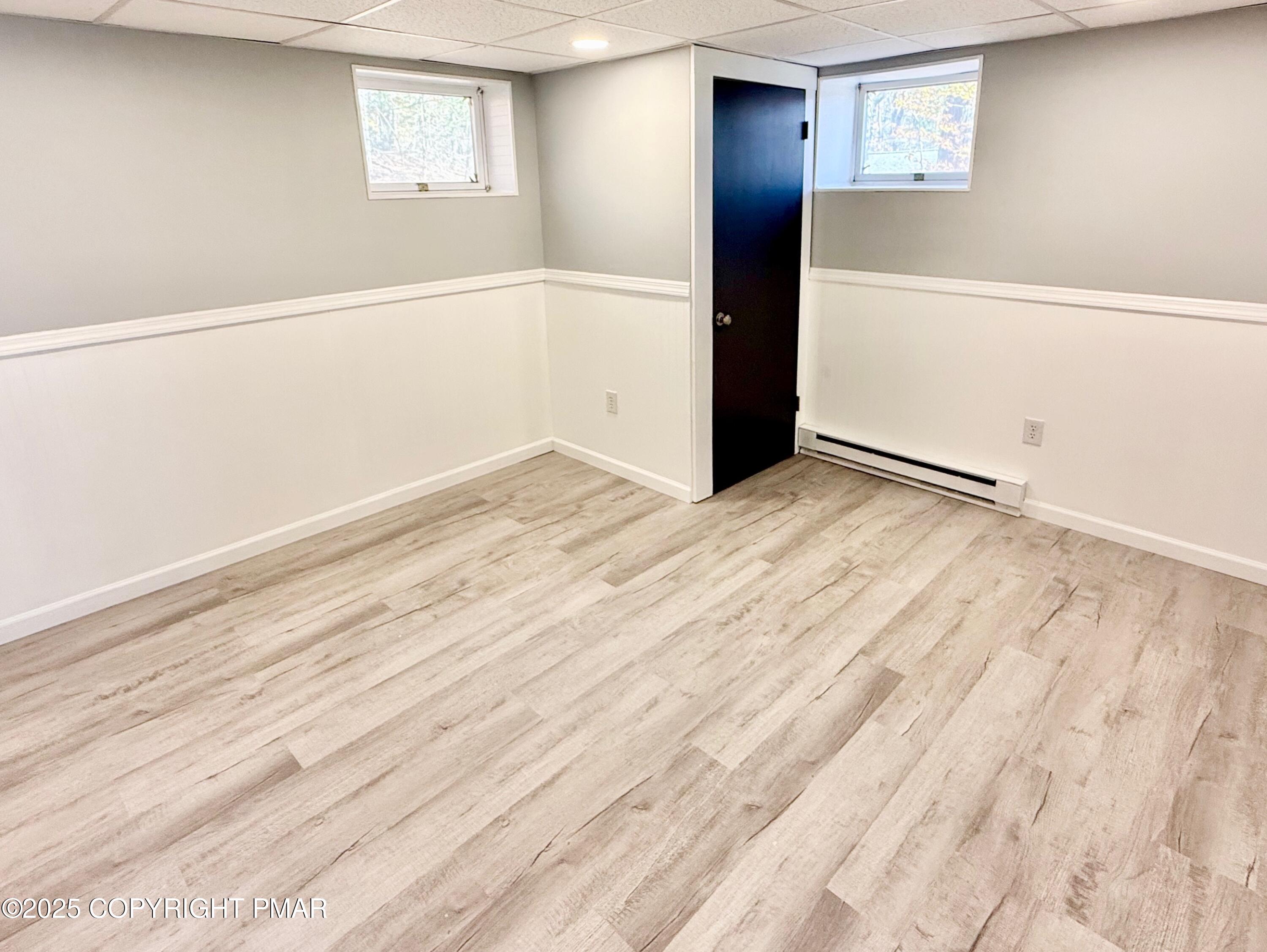 111 Lake In The Clouds Road Canadensis, PA 18325 - Photo 33 of 39 an empty room with wooden floor