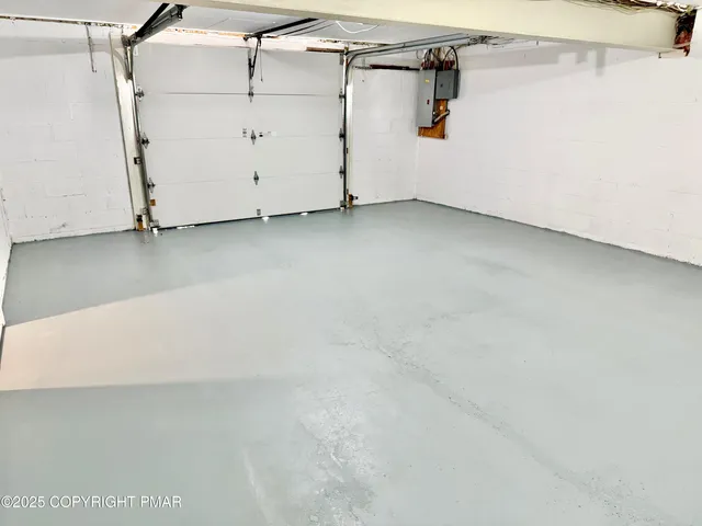 a view of a house with snow on the side of the road