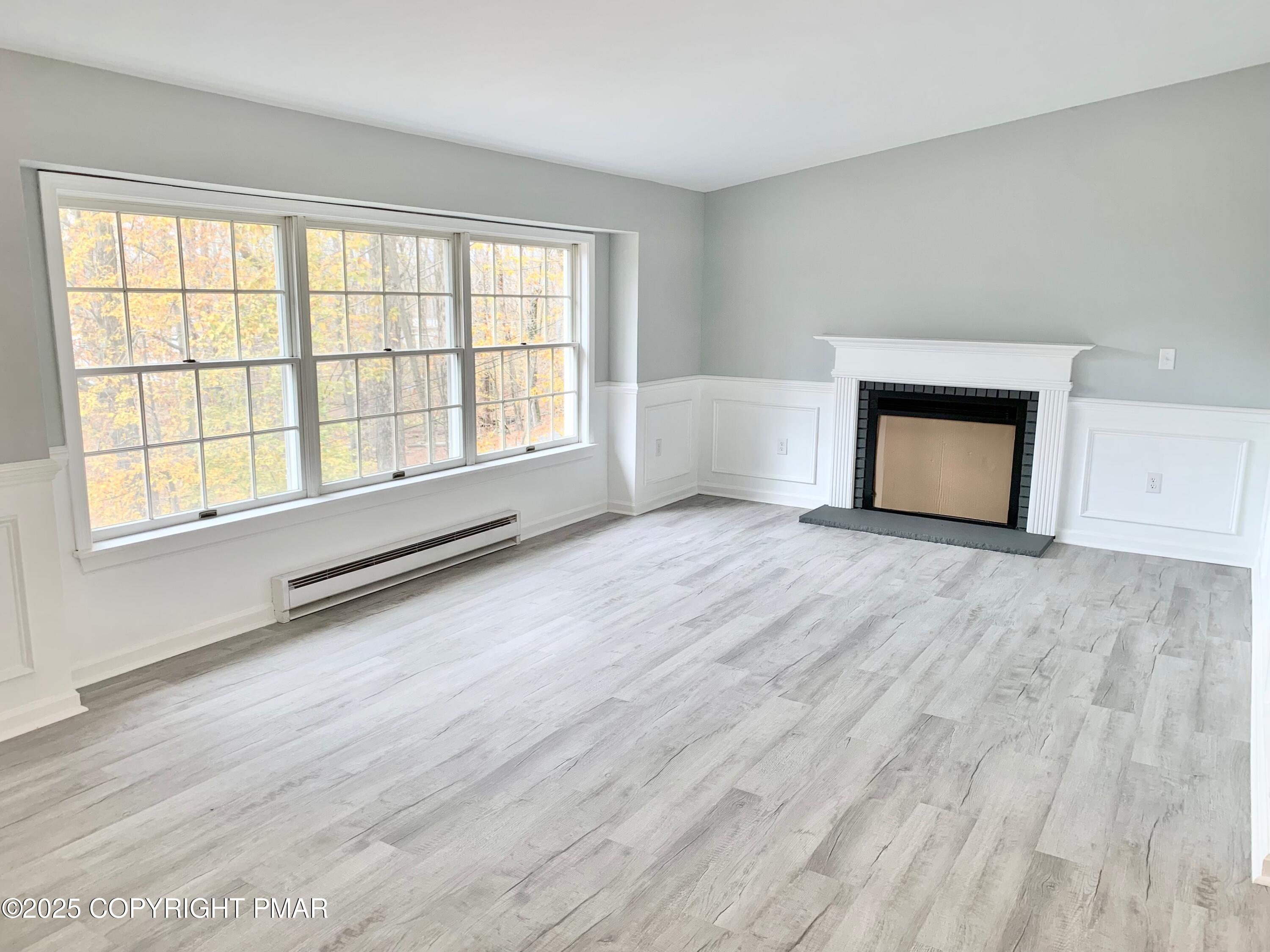 111 Lake In The Clouds Road Canadensis, PA 18325 - Photo 5 of 39 a view of an empty room with a window and wooden floor