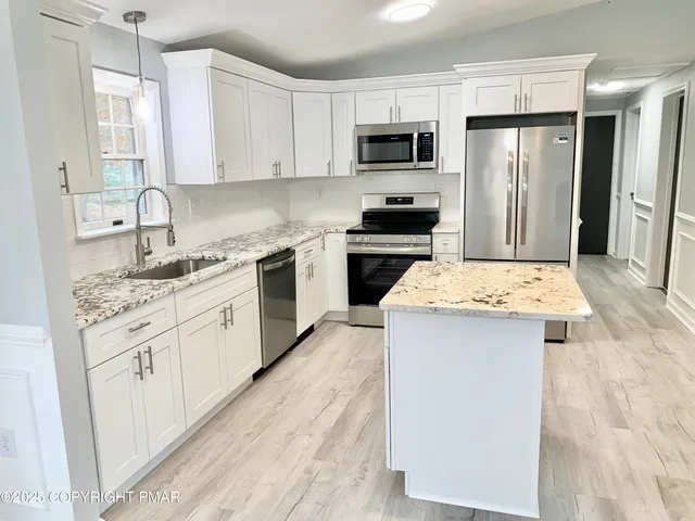 a kitchen with a sink stove and refrigerator