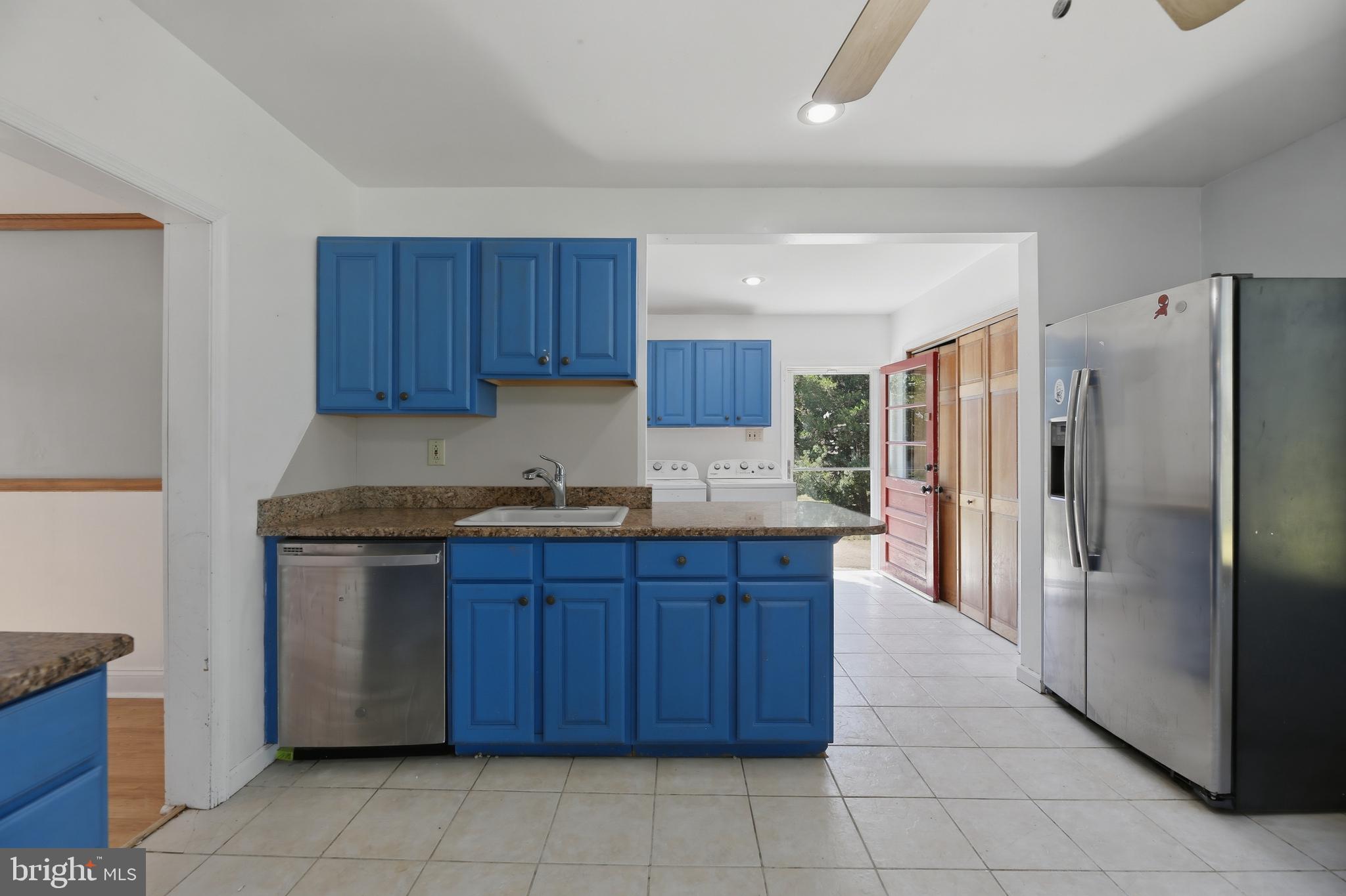 448 North Chew Road Hammonton, NJ 08037 - Photo 13 of 45 Vibrant kitchen with blue cabinetry.